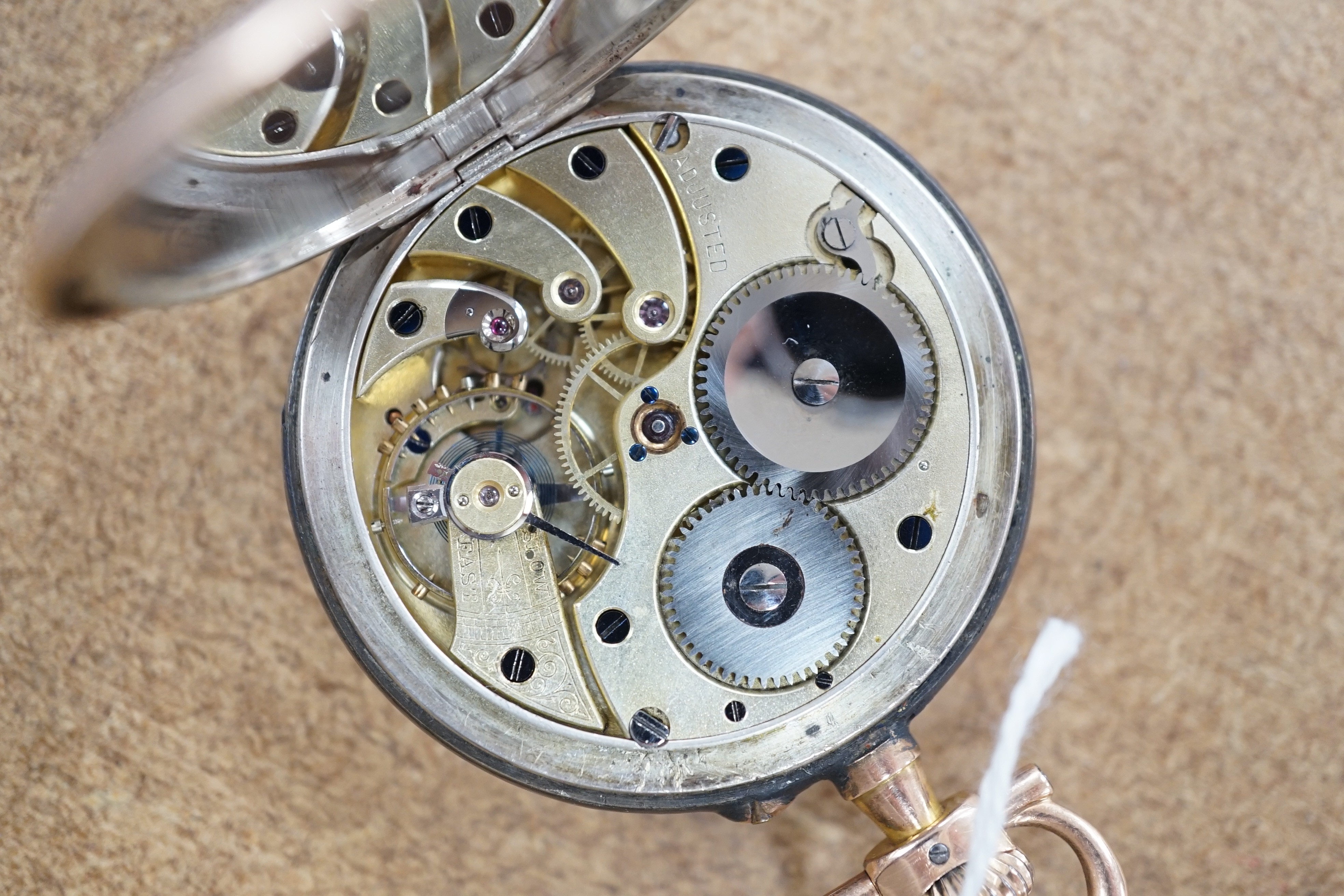 A late 19th century Swiss 935 white metal, gold plated and black enamel keyless lever open face pocket watch, in fitted case.